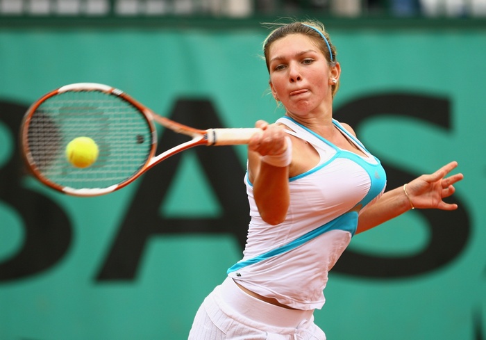 Simona Halep playing tennis on a clay court