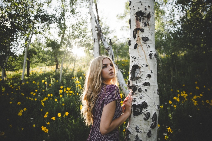 Woman with blonde hair in a field of yellow flowers