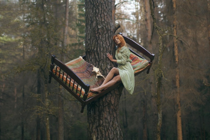 Woman in a bed in a forest