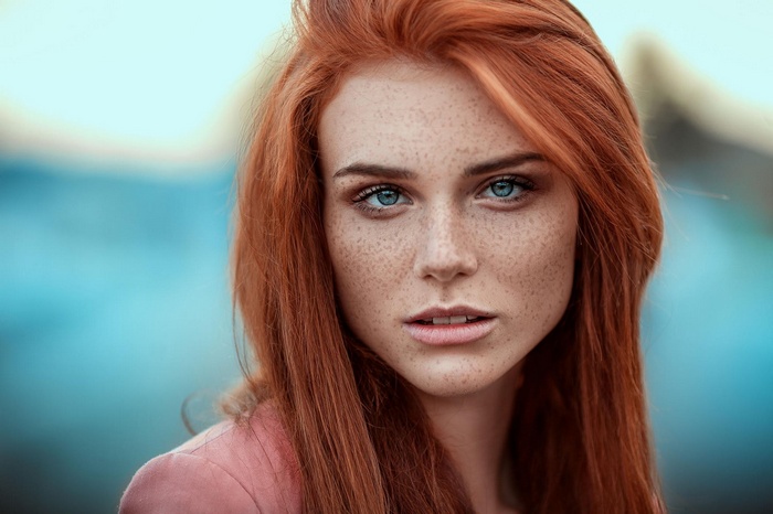 Redhead woman with blue eyes and freckles
