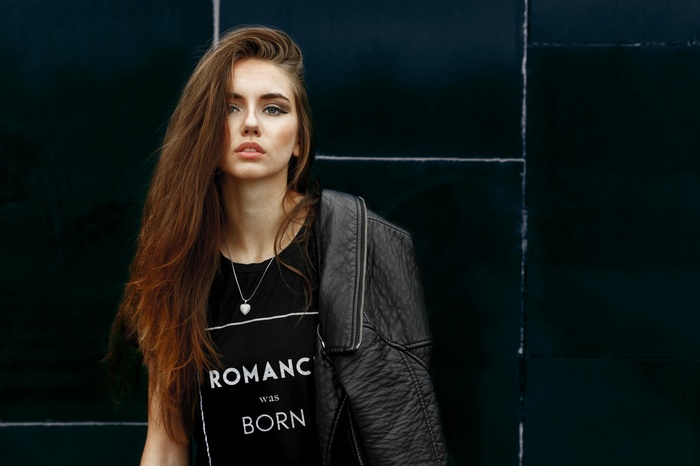Woman with long hair wearing a t-shirt and leather jacket