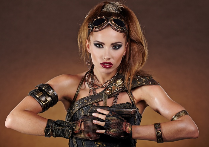 Steampunk woman with goggles and a gun