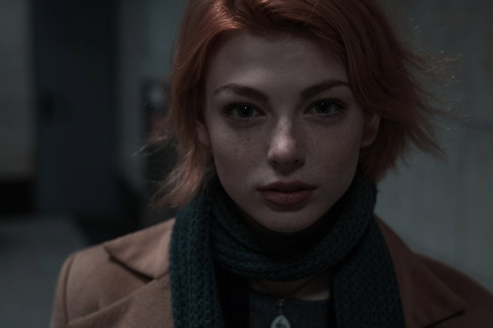 Mayya Giter with freckles and red hair wearing a scarf