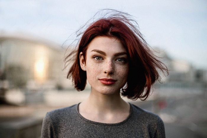 Portrait of Mayya Giter with red hair and freckles outdoors