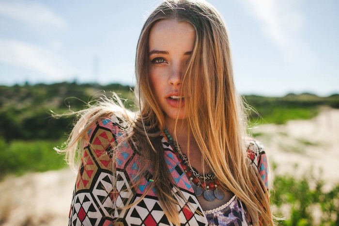 Woman with blonde hair and freckles outdoors
