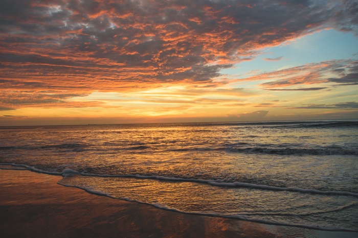 Sunset over the ocean with colorful clouds