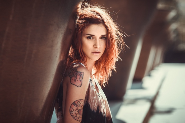 Woman with red hair and tattoos