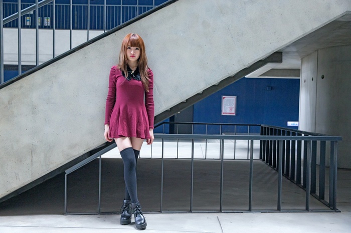 Asian woman in a maroon dress and thigh-highs