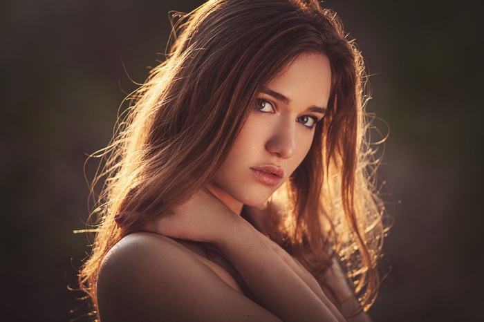 Portrait of a young woman with long brown hair
