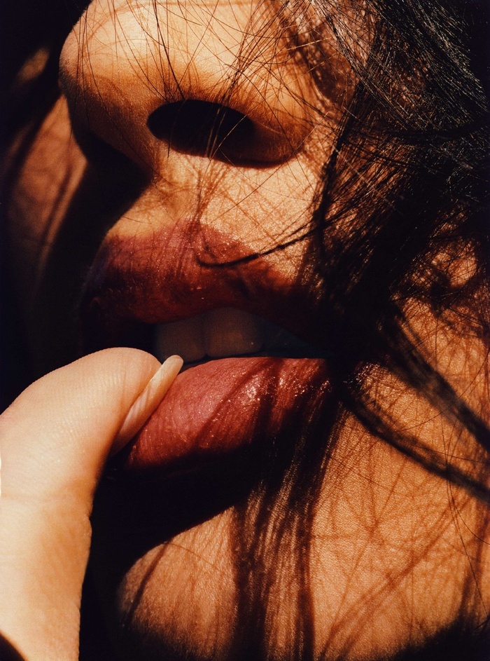Woman's mouth with finger and tongue