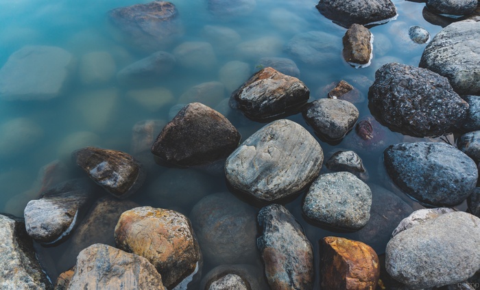 Rocks submerged in clear blue water