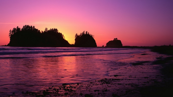 Sunset over the ocean with rocky islands