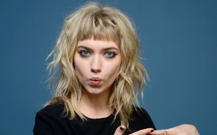 Imogen Poots with blonde wavy hair and blue eyes