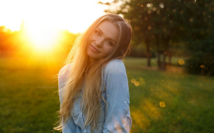 Woman with long blonde hair at sunset