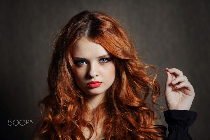 Portrait of a young woman with red hair