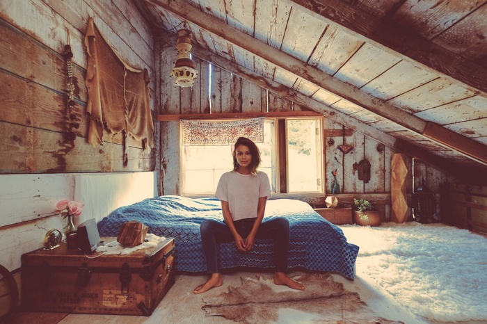 Nathalie Kelley in a rustic attic bedroom