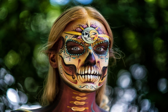 Woman with Dia de los Muertos skull face paint