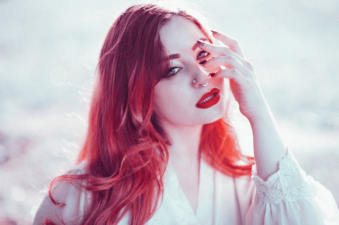 Redhead woman with red lipstick and nose ring