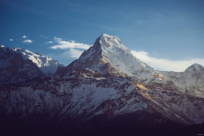 Snow-capped mountains under a blue sky