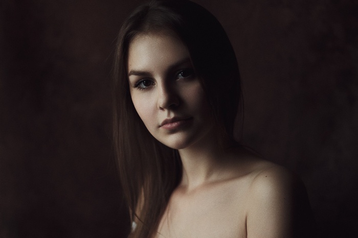 Portrait of a young woman with brown hair and eyes