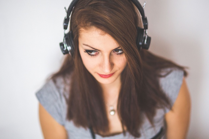 Woman with headphones looking down