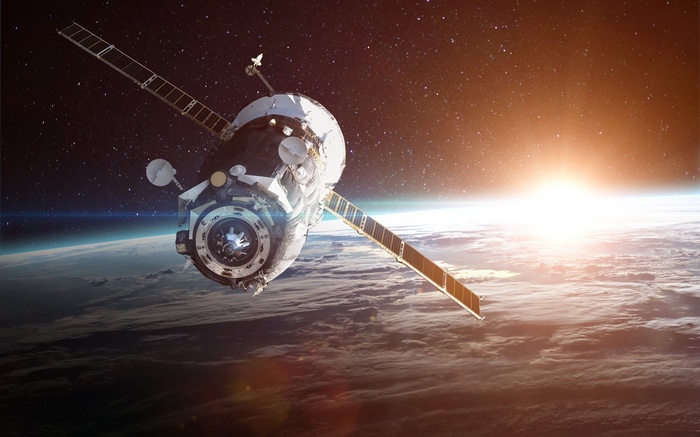 Space station orbiting Earth with sunrise