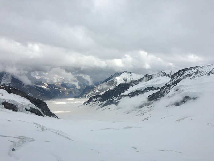 Snowy mountain range with clouds