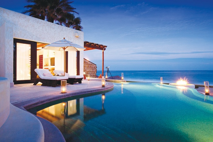 Luxury infinity pool at dusk with ocean view