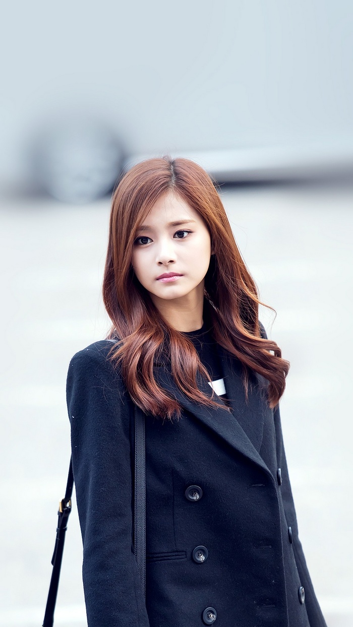 Tzuyu from Twice wearing a black coat
