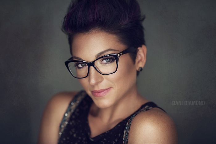 Woman with short dark hair and glasses