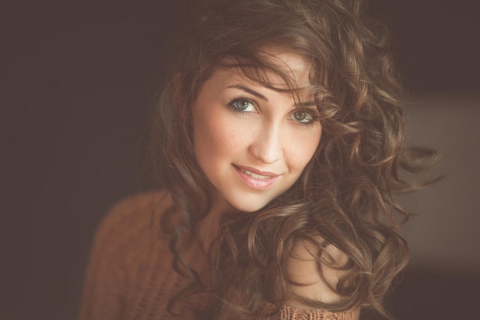 Portrait of a smiling woman with curly brown hair