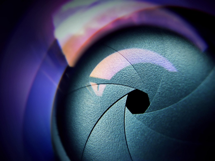 Close-up of a camera aperture with reflections