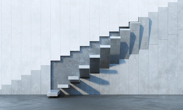 Concrete stairs against a tiled wall