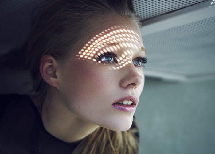 Woman with freckles and blue eyes looking away