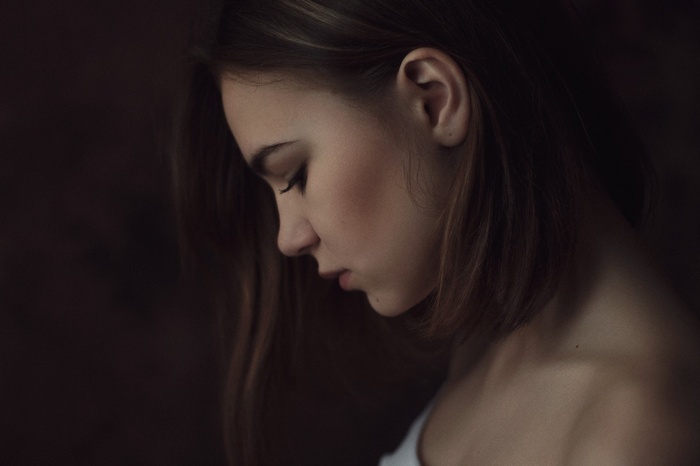Woman in profile looking down