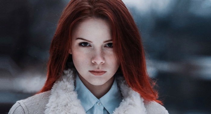 Portrait of a young woman with red hair