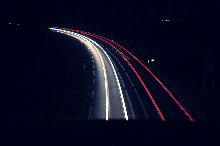 Long exposure of car lights on a dark road at night