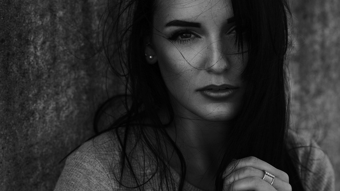 Monochrome portrait of a woman with hands in hair