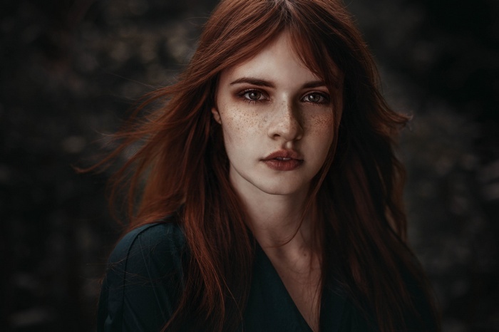 Redhead woman with freckles looking at viewer