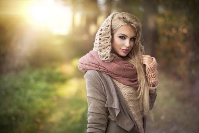 Blonde woman wearing scarf and gloves outdoors