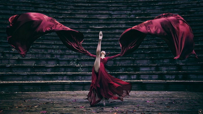 Ballerina in a red dress with flowing fabric
