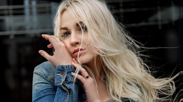 Woman with blonde hair and nose ring in denim jacket
