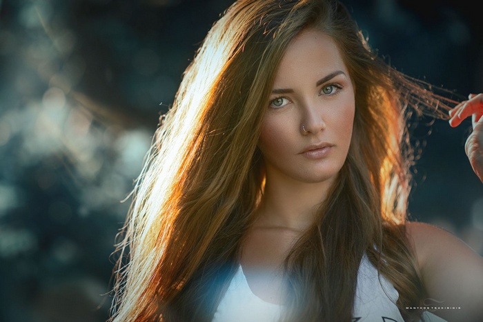 Model Manthos Tsakiridis with hands in hair in sunlight