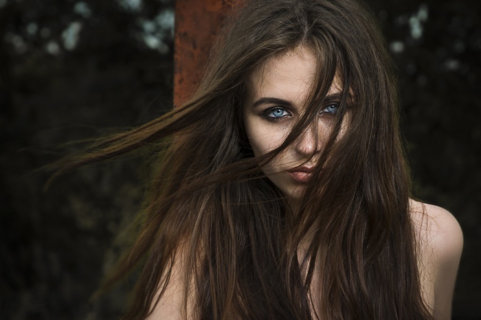 Woman with long brown hair and blue eyes