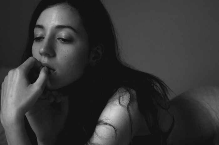 Monochrome portrait of a woman lying down