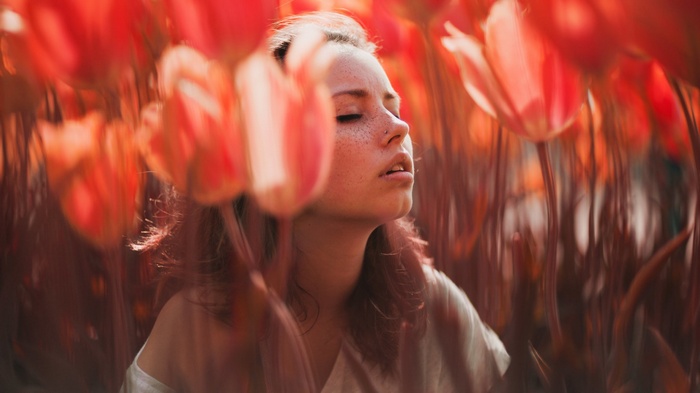 Ruby James among red tulips