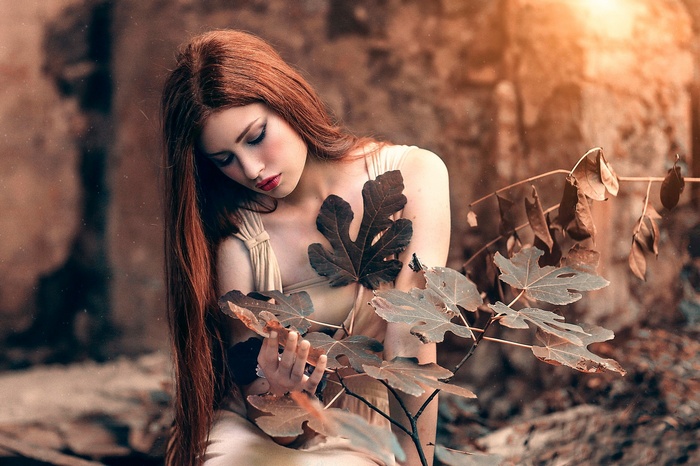 Valentina Galassi with long red hair and leaves