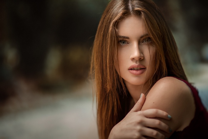 Woman with long brown hair looking at viewer