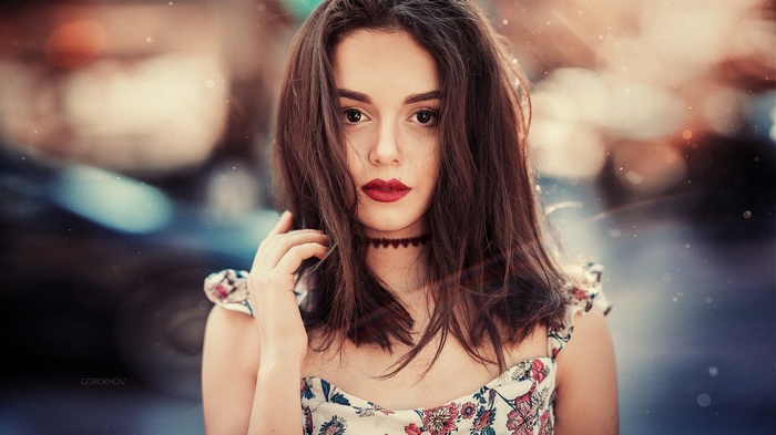 Portrait of a woman with red lipstick and a floral dress