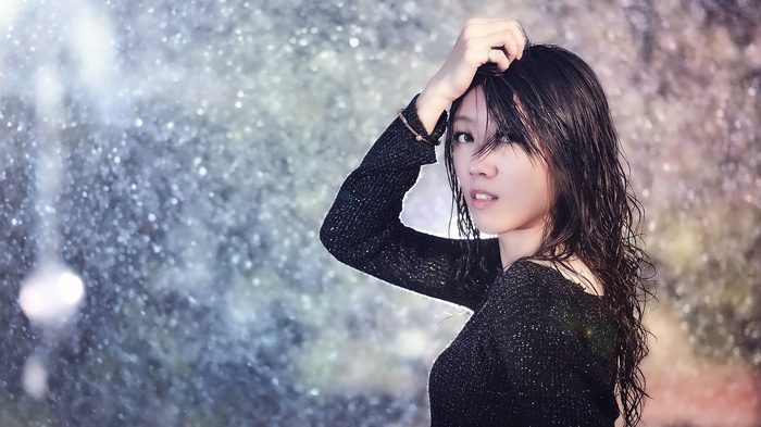 Asian woman with wet hair in the rain